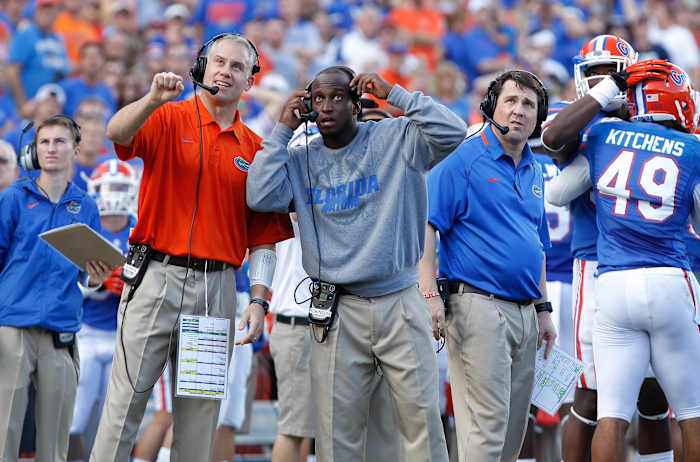Nov 23, 2013; Gainesville, FL, USA; Florida Gators defensive coordinator D.J. Durkin, defensive backs coach Travaris Robinson and head coach Will Muschamp during the second quarter against the Georgia Southern Eagles at Ben Hill Griffin Stadium. (Kim Klement / USA TODAY Sports).